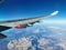 View from the porthole on the wing of an airplane with a red aircraft engine flying to Cyprus, in the morning over the beautiful