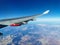 View from the porthole on the wing of an airplane with a red aircraft engine flying to Cyprus, in the morning over the beautiful