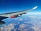 View from the porthole on the wing of an airplane with a red aircraft engine flying to Cyprus, in the morning over the beautiful