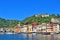 View of Portofino restaurants, on a blue sky day, Portofino, Liguria, Italy.