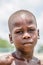 View of a portrait of African boy, child with expressive look on his wet face and deep suffering eyes