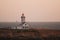 View of the Poulains lighthouse at the northern tip of Belle Ile at sunset, Brittany