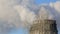 View of power heat station, smoke from the chimney on frosty winter day