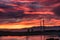 View of power plant chimneys against dramatic sunset sunrise sky.