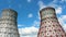 View of the power plant and cooling towers. The smoke goes out from a cooling tower of an operating power station. Cooling towers