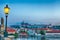 View of Prague Castle, mala Strana and Vltava river in Prague from Charles Bridge with street lamp during blue hour sunrise