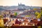 View of Prague Castle over red roof from Vysehrad area at sunset lights, Prague, Czech Republic