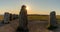 View of the prehistoric Ales Stenar ship setting on the southern coast of Sweden at sunset  with a sun star