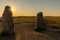 View of the prehistoric Ales Stenar ship setting on the southern coast of Sweden at sunset  with a sun star