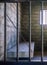 View of the prison cell through bars with sun shining through the window