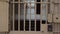 View of the prison corridor through the bars on the door.