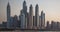 View from Promenade on Dubai Marina modern Towers from day to night.