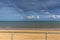 A view from the promenade out to sea off Skegness beach, UK with a modern wind farm and rainbow visible on the horizon