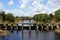 View of a protective concrete dam with a sluice to drain water to protect land from flooding on a clear sunny day.