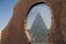 A view of The pyramid of Cestius in a rusty metal frame, is a Roman Era pyramid in Rome