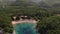 View of Queens Beach surrounded by greenery and mountains. Drone