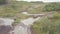 View of race track on quad bikes. Clip. Top view of quad bikes passing puddles of mud at races. Cross-country motorcycle