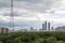 View of the radio tower, the site of high-rise construction buildings, industrial cranes and apartment buildings in the green zone