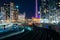 View of railroad tracks and modern buildings in downtown at nigh