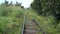 View of railroad tracks from a moving trolley cart.