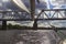 View of the railway bridge from the yacht. Part of the boom of the yacht. Storm clouds in the sky