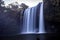 View on Rainbow falls with a cavern under a cliff behind the falls in Kerikeri after sunset