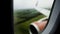 View through rainy window of airplane successfully landing runway at airport