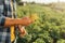 View of rancher holding gloves while