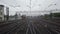 View from the rear last window of the vestibule of a railway car while driving in rainy weather