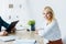 View of recruiter with clipboard near happy employee looking at camera