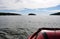 View from a red inflatable boat in Ladoga Skerry lake. Islands and mountains