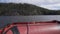 View from a red inflatable boat in Ladoga Skerry lake. Islands and mountains