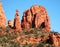 A View of Red Rocks, Blue Sky, and Green Trees