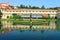 View of reflection in a lake in Wallenstein Garden, its statues and fountain, red tiled