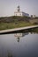View and reflection of the Punta Insua or Larino lighthouse in Carnota, Galicia, Spain