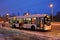 View of a regular trolleybus taking passengers to a public transport stop on an early winter morning.