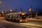 View of a regular trolleybus taking passengers to a public transport stop on an early winter morning.