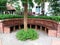 view of relaxing zone, Brick chair relaxing in the garden.Relax corner with many kind of green trees.