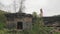 View of remains of old wooden house with chimney made of brick after fire.