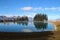 View of a reservoir lake for artificial snow, ski lift and surrounding mountains, in autumn. Austria.