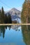 View of a reservoir lake for artificial snow, ski lift and surrounding mountains, in autumn. Austria.