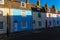 View of residential buildings along the street going up, colorful facades of buildings, typical colors of the seaside village