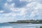 View of resort buildings on tropical island against cloudy sky