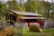 View of a Restored Burr Truss Covered Bridge on a Country Road With Stone Approach Walls