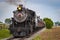 View of a Restored Steam Train Approaching Head-On Blowing Smoke and Steam