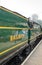 View of a restored, vintage British steam locomotive complete with the two engine drivers.