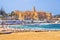 View of Ribat, the Mediterranean Sea with waves and people who relax and play soccer, Monastir, Tunisia