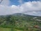 View of rice fields, mountains behind the clouds from the top of the hill