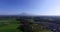 The view of rice fields and trees and mountains on the island of Bali.