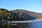 A view of the of the river and autumn colours of the surrounding mountains, seen from Togetsu-kyo bridge.